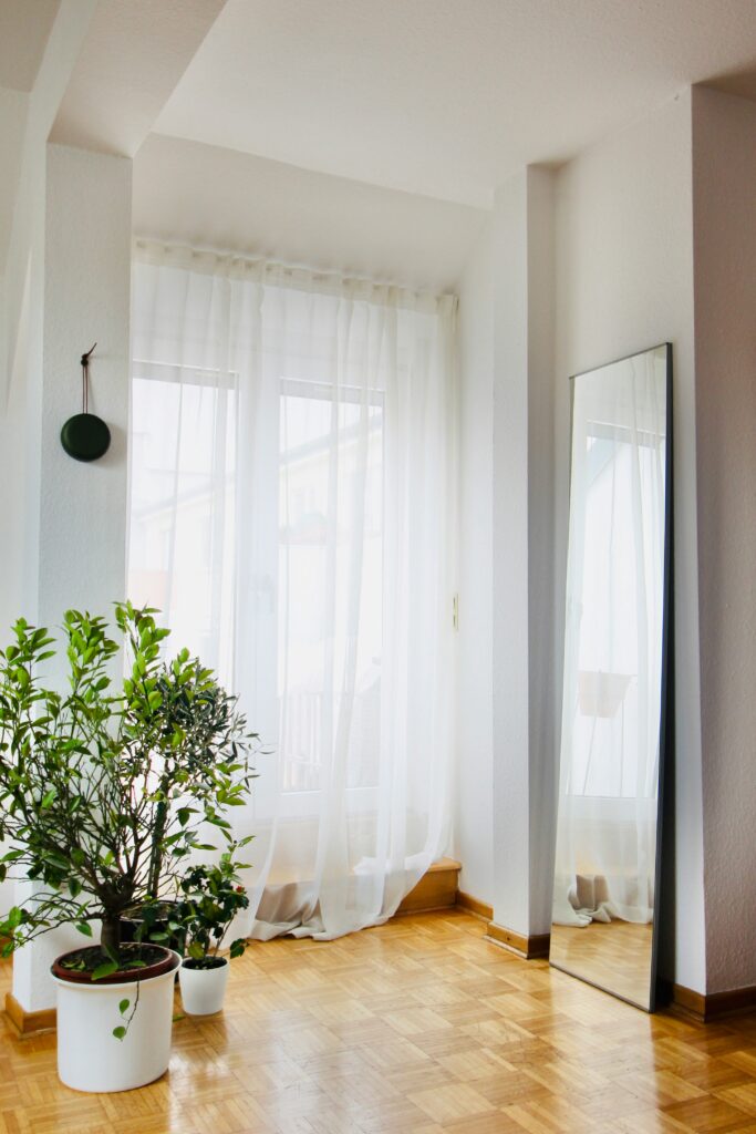 Room with tall mirror leaning against walls next to window

decorating ideas