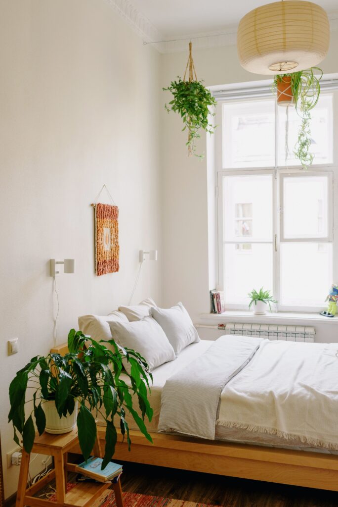 white bedroom with white bed and plants

staging design