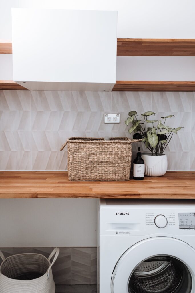 storage basket on a shelf in a laundry room 

staging design