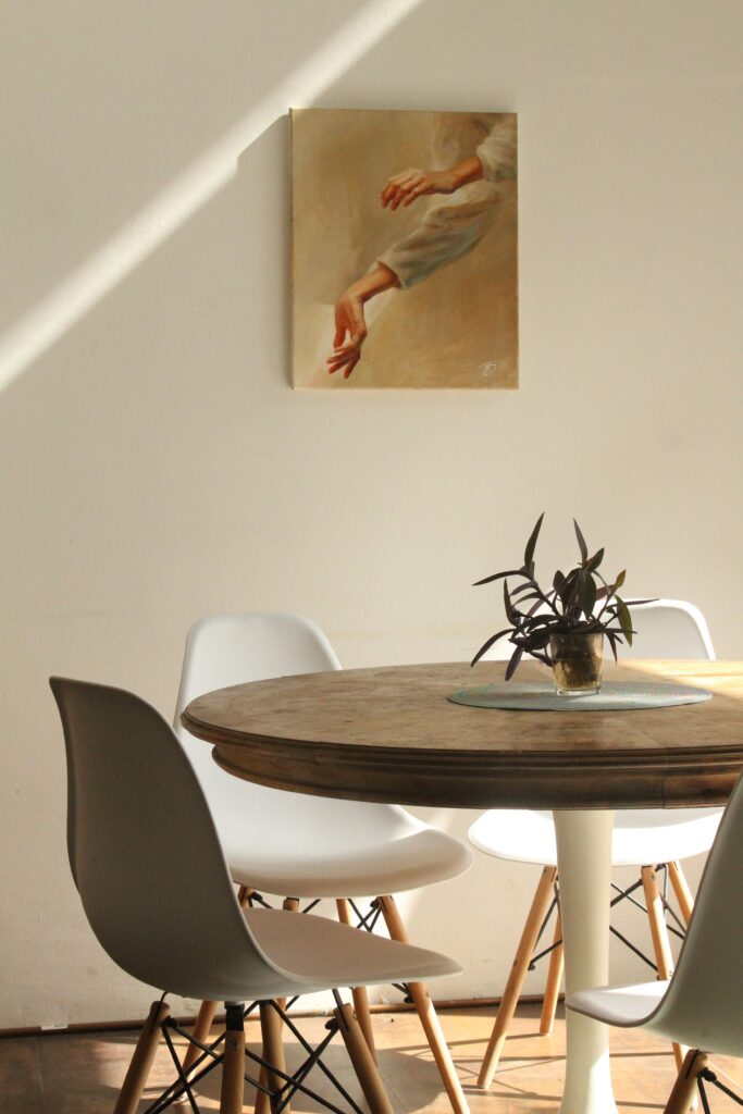 art above a round dining table with a plant on it

staging design